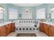 Ensuite bathroom features double vanity, soaking tub, and decorative tile details at 133 Torino Ln, Kissimmee, FL 34759
