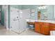 Ensuite bathroom featuring glass enclosed shower, vanity area, and tile flooring at 133 Torino Ln, Kissimmee, FL 34759