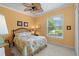 Cozy bedroom with a floral-patterned bedspread and a window offering views of the outdoors at 133 Torino Ln, Kissimmee, FL 34759