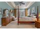 Well-appointed bedroom features tray ceilings, a four-poster bed, and a large dresser with a mounted television at 133 Torino Ln, Kissimmee, FL 34759