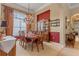 Elegant dining room featuring a large arched window, chandelier, hutch, and a table with seating for six at 133 Torino Ln, Kissimmee, FL 34759