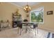 Dining room features tile flooring, a chandelier, and a view of the golf course at 133 Torino Ln, Kissimmee, FL 34759