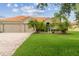 Charming single-Gathering home with a tile roof, lush lawn, and a three car garage at 133 Torino Ln, Kissimmee, FL 34759