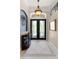 Elegant foyer with tile flooring, decorative light fixture, and glass paneled doors at 133 Torino Ln, Kissimmee, FL 34759