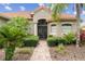 Inviting front entrance with manicured bushes and double door entry at 133 Torino Ln, Kissimmee, FL 34759