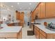 Bright kitchen features white countertops, light wood cabinets, tile floors, and stainless steel appliances at 133 Torino Ln, Kissimmee, FL 34759