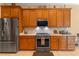 Stainless steel appliances and quartz countertops in this well-equipped kitchen at 133 Torino Ln, Kissimmee, FL 34759
