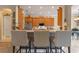 Kitchen with stainless steel appliances, light countertops, light wood cabinets, and bar seating for three at 133 Torino Ln, Kissimmee, FL 34759