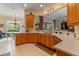 Eat-in kitchen with stone countertops and wood cabinets at 133 Torino Ln, Kissimmee, FL 34759