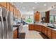 Large kitchen with wood cabinets, stainless steel appliances, and an adjacent breakfast nook at 133 Torino Ln, Kissimmee, FL 34759