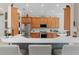 Kitchen bar with seating. Wood cabinets, stainless steel appliances, and white countertops at 133 Torino Ln, Kissimmee, FL 34759