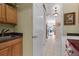 Laundry room with wooden cabinets, a sink, and a view into the adjacent rooms and laundry appliances at 133 Torino Ln, Kissimmee, FL 34759