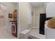 Laundry room with a red front-loading washer and dryer, cabinets, and a small bench at 133 Torino Ln, Kissimmee, FL 34759