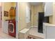 Spacious laundry room with washer, dryer, storage cabinets, bench seating, and outdoor access at 133 Torino Ln, Kissimmee, FL 34759