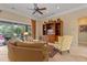 Cozy living room with tile floors, stylish furniture, a ceiling fan, and a view of the screened outdoor patio at 133 Torino Ln, Kissimmee, FL 34759