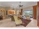 Bright living room with tile floors, stylish furniture, a ceiling fan, and an open layout to the outdoor patio at 133 Torino Ln, Kissimmee, FL 34759
