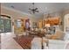 Spacious living room with tile floors, stylish furniture, a ceiling fan, and an open layout to the kitchen at 133 Torino Ln, Kissimmee, FL 34759