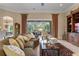 Spacious living area with large windows, comfortable seating, and views of a covered outdoor dining space at 133 Torino Ln, Kissimmee, FL 34759