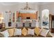 Open concept living room with kitchen bar and eat-in seating. Wood cabinets and stainless steel appliances at 133 Torino Ln, Kissimmee, FL 34759