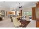 Open-concept living room featuring tile floors, ceiling fan, and access to the lanai at 133 Torino Ln, Kissimmee, FL 34759