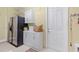 Mud room featuring white cabinets, stainless steel refrigerator, and ample storage space at 133 Torino Ln, Kissimmee, FL 34759