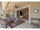 Comfortable covered patio seating area with ceiling fan and view to living room at 133 Torino Ln, Kissimmee, FL 34759