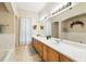 Large bathroom features double sinks, white countertops, decorative accents and a bath tub at 1411 Celebration Ave # 106, Celebration, FL 34747