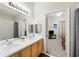 Bright bathroom features double sinks, a large mirror, and a door opening to the bedroom at 1411 Celebration Ave # 106, Celebration, FL 34747