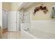 Bathroom features a soaking tub, glass enclosed shower and floral decorations at 1411 Celebration Ave # 106, Celebration, FL 34747