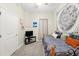 Bedroom with two twin beds, light gray carpet, TV, and decorative wall hangings at 1411 Celebration Ave # 106, Celebration, FL 34747