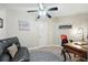 Cozy bedroom with a ceiling fan, comfortable seating, and a decorative rug at 1411 Celebration Ave # 106, Celebration, FL 34747