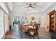 Bright dining room with tray ceiling, hardwood floors, and a beautiful view of the outdoor area at 1411 Celebration Ave # 106, Celebration, FL 34747
