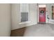 Inviting entryway with a red door adorned with a wreath, and a decorative heron statue at 1411 Celebration Ave # 106, Celebration, FL 34747