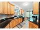 Spacious kitchen features granite countertops, wood cabinets, and plenty of counter space at 1411 Celebration Ave # 106, Celebration, FL 34747