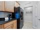 Well-lit kitchen features black appliances, granite countertops and tiled floors at 1411 Celebration Ave # 106, Celebration, FL 34747