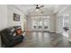 Bright living room with hardwood floors, tray ceilings, and outdoor access at 1411 Celebration Ave # 106, Celebration, FL 34747