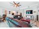 This living room includes a ceiling fan, two sofas, accent rug, and a nearby dining and kitchen area at 1411 Celebration Ave # 106, Celebration, FL 34747