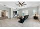 Large open-concept living room featuring tile floors, ceiling fan and neutral paint at 1411 Celebration Ave # 106, Celebration, FL 34747