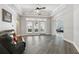 Spacious living room featuring wood floors, high tray ceiling and lots of natural light at 1411 Celebration Ave # 106, Celebration, FL 34747