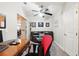 Well-lit office with a comfortable seating area, desk, ceiling fan and barn door at 1411 Celebration Ave # 106, Celebration, FL 34747