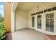 Exterior patio space with neutral colors and a view of some greenery, perfect for relaxing outdoors at 1411 Celebration Ave # 106, Celebration, FL 34747