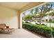 Covered patio with a view of the street and mature landscaping, offering a serene outdoor space at 1411 Celebration Ave # 106, Celebration, FL 34747