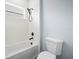 Bathroom showcasing tub and shower with white subway tile, black fixtures, and a standard white toilet at 145 Willow Dr, Poinciana, FL 34759