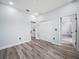 Spacious bedroom featuring wood-look flooring, light blue walls, and an ensuite bathroom at 145 Willow Dr, Poinciana, FL 34759