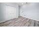 Light and airy bedroom with wood-look floors, a closet with white doors, and freshly painted walls at 145 Willow Dr, Poinciana, FL 34759