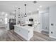 A modern kitchen featuring stainless steel appliances, a central island, and stylish pendant lighting at 145 Willow Dr, Poinciana, FL 34759