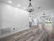 Bright open-concept living room featuring modern light fixtures, sleek flooring, and a stylish textured wall at 145 Willow Dr, Poinciana, FL 34759