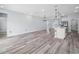 Open-concept living space featuring modern light fixtures, sleek flooring, and a bright, airy atmosphere at 145 Willow Dr, Poinciana, FL 34759