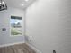 Close-up of a textured wall in a room featuring modern flooring and a bright window at 145 Willow Dr, Poinciana, FL 34759