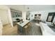 Open-concept living room and kitchen boasts modern gray cabinetry, island seating, and stainless steel appliances at 16837 Sw 47Th Court Rd Rd, Ocala, FL 34473